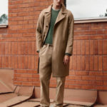 A man standing in front of a brick building