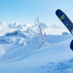 A man standing on top of a snow covered mountain