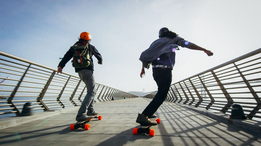 A man riding a skateboard up the side of a fence