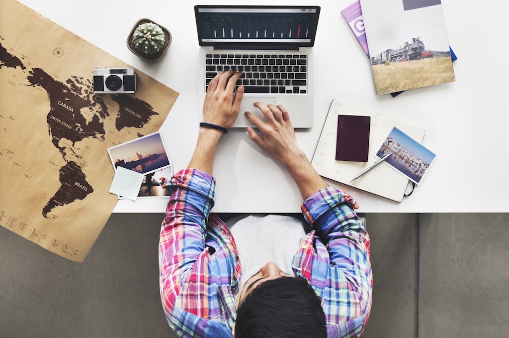 A person sitting at a table using a laptop