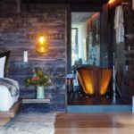 A fire place sitting in a chair next to a fireplace
