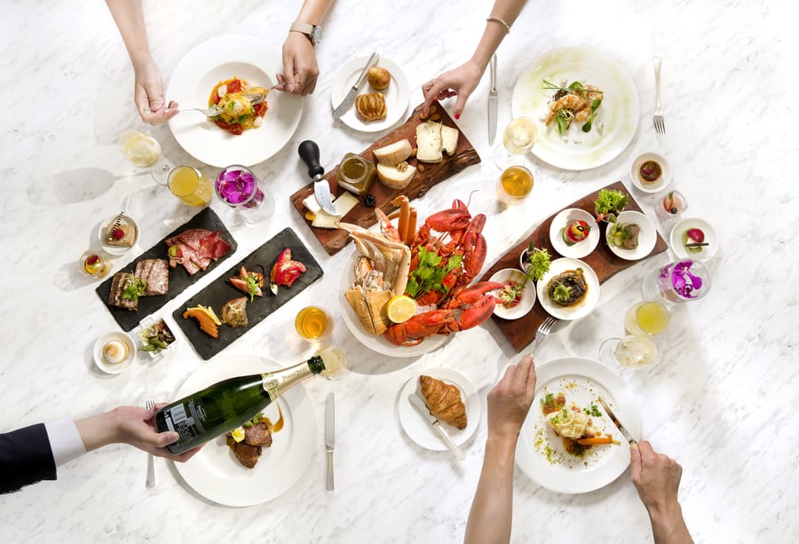 A group of people sitting at a table with a plate of food