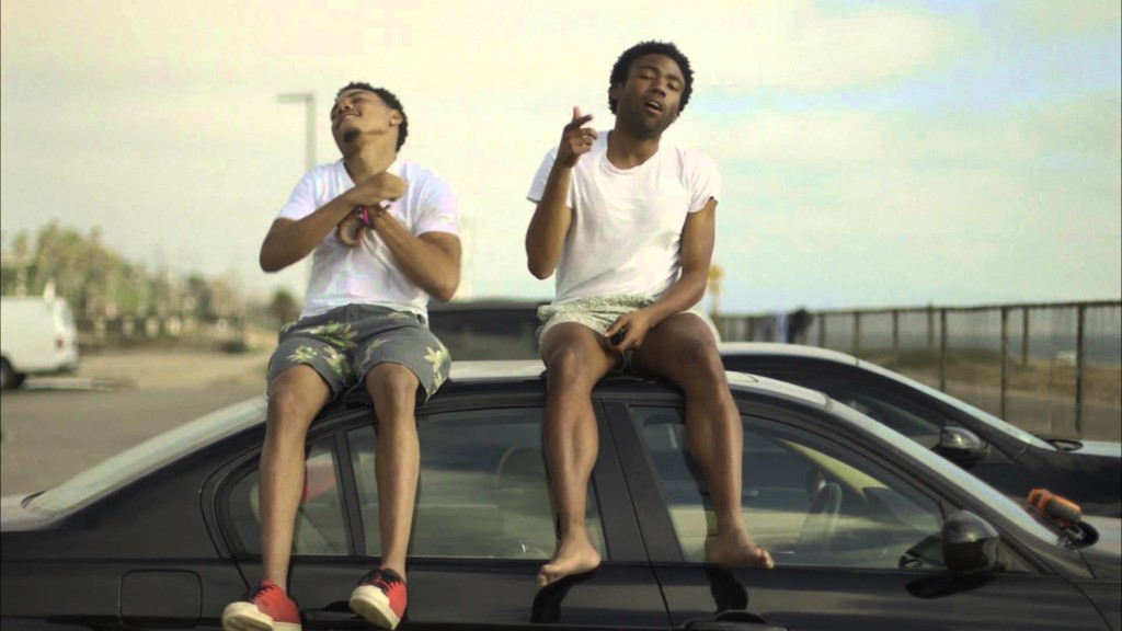 A man and a woman sitting in a parking lot