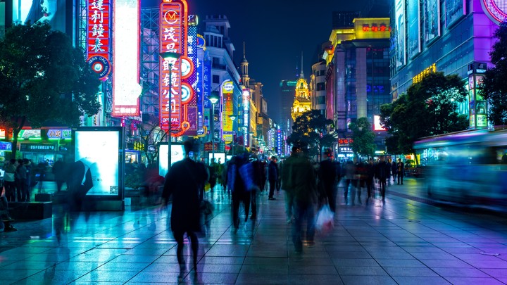 A group of people walking on a city street