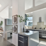 A kitchen with a sink and a mirror