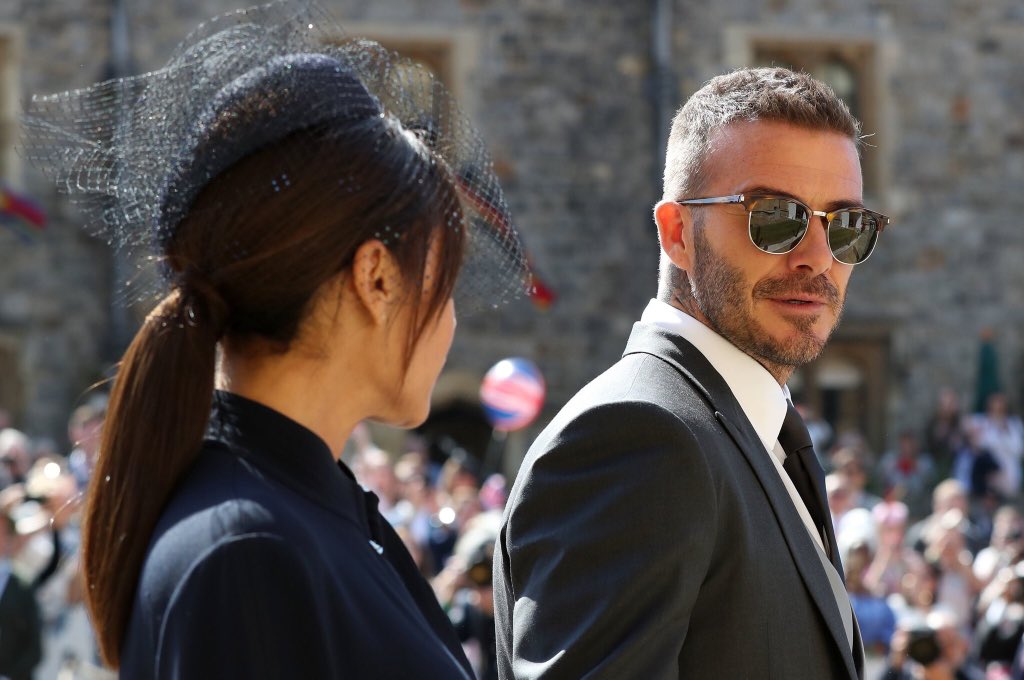 A person wearing sunglasses and standing in front of a crowd