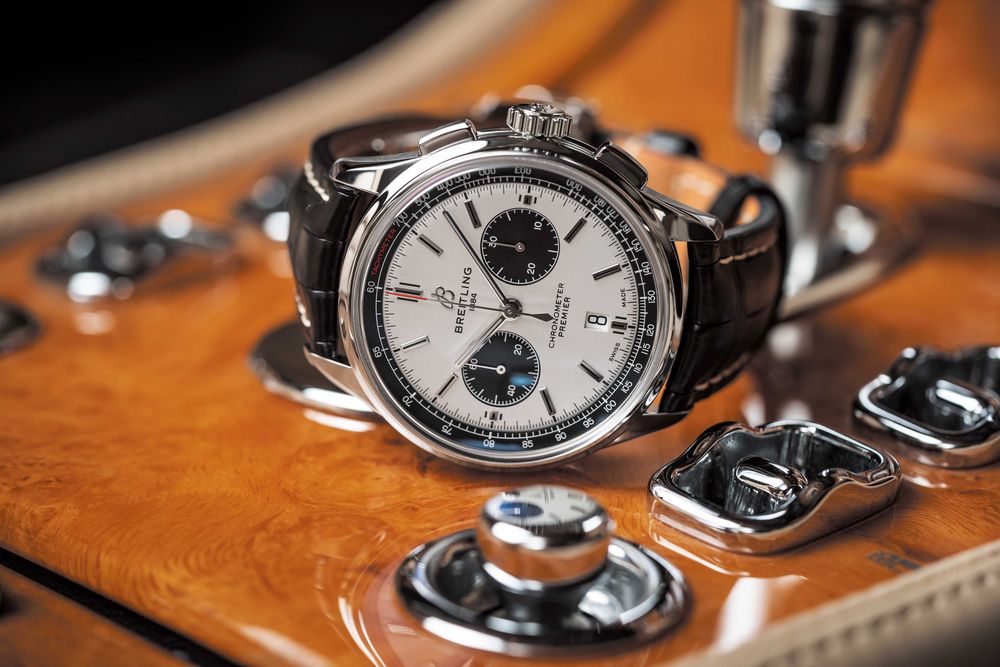 A watch sitting on top of a wooden table