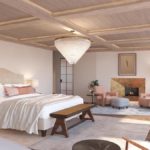 A bedroom with a bed and a chair in a room