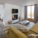 A bedroom with a view of a living room