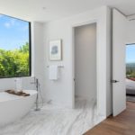 A room with a sink and a large window