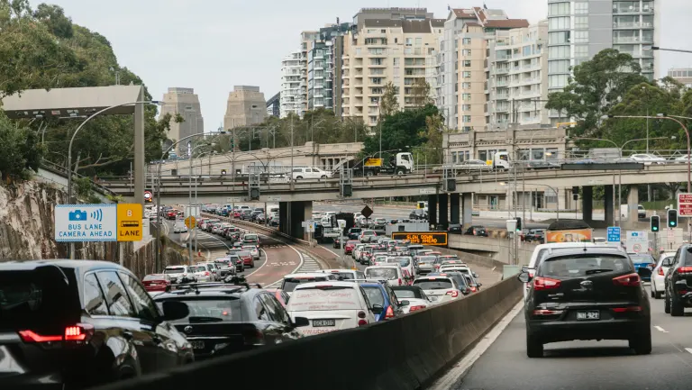 A car driving on a city street filled with lots of traffic