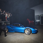 A blue car parked in a dark room