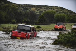 A truck driving down a dirt road