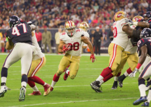 A group of people playing football on a field