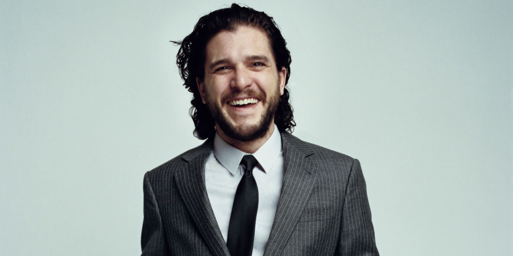 A man wearing a suit and tie smiling at the camera