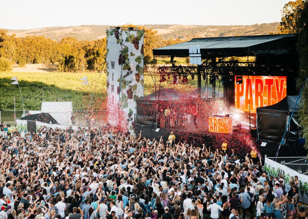 A group of people standing in front of a large crowd of people