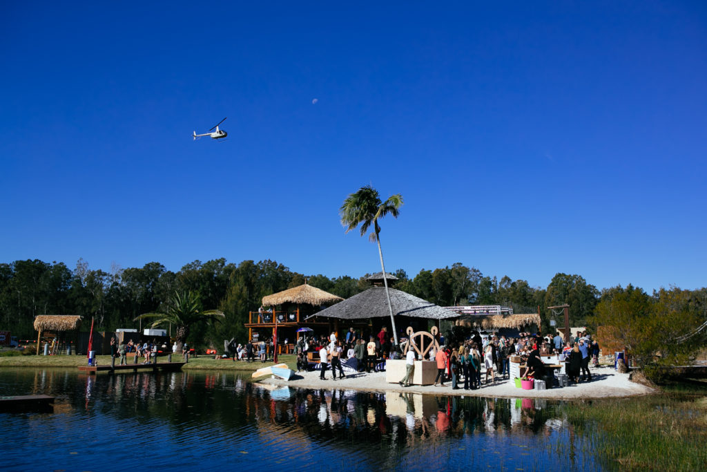 A group of people on a dock next to a body of water