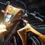 A motorcycle parked in front of a brick wall