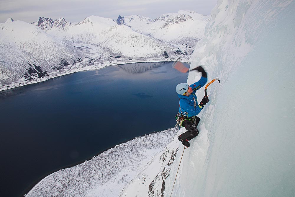 A man riding skis down a snow covered mountain