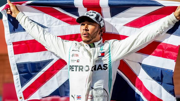 A man wearing a uniform and holding a flag