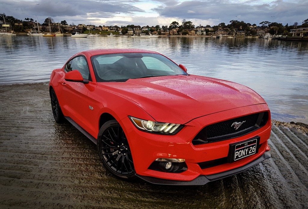 A car parked next to a body of water