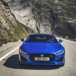 A blue car parked on the side of a mountain