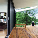 A wooden bench sitting next to a window