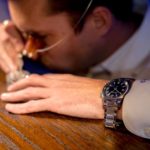 A person drinking from a glass
