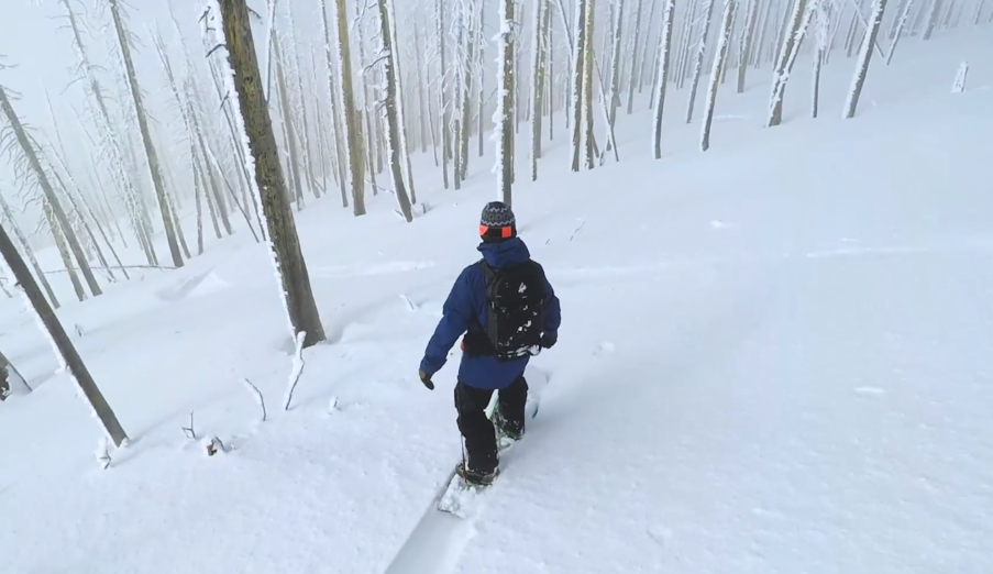 A man riding skis down a snow covered slope