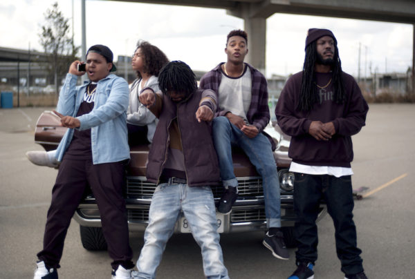 A group of people standing in a parking lot