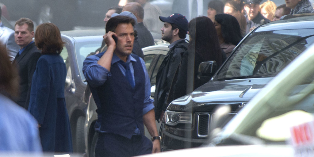 A group of people in a car talking on a cell phone