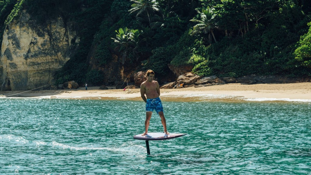 A person riding a surf board on a body of water