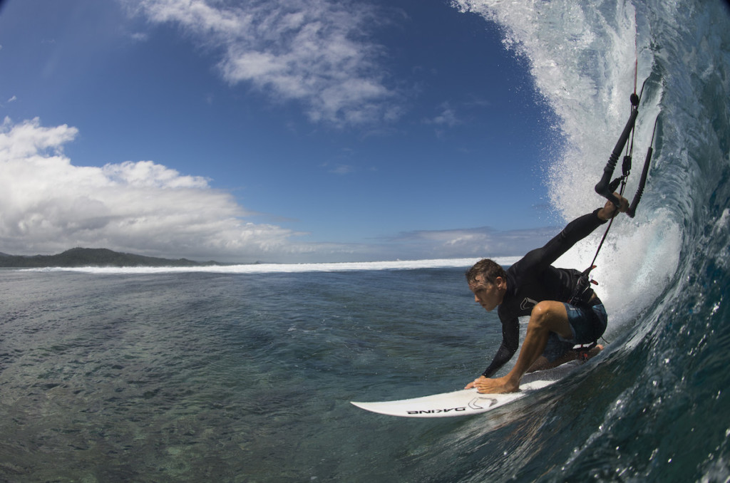 A man riding a wave on a surf board on a body of water