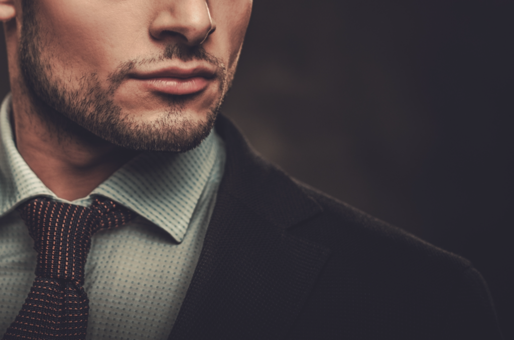 A man wearing a suit and tie looking at the camera