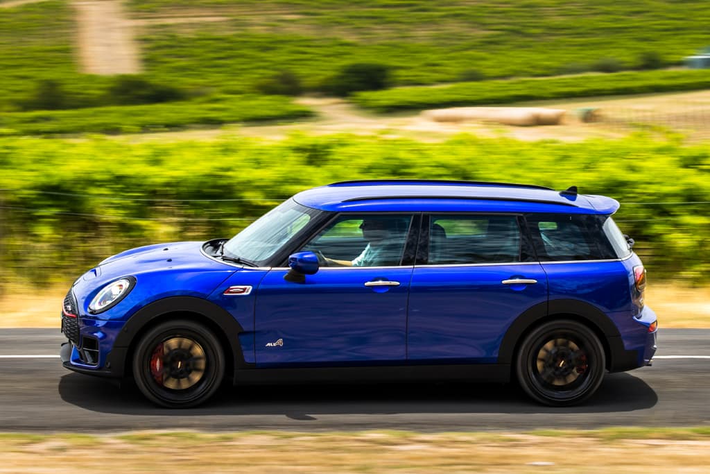 A blue car driving on a road