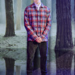 A man standing in front of water