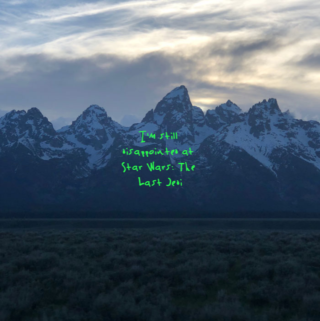 A sign with a mountain in the background