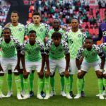 A group of football players posing for a picture