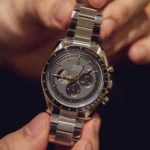 A hand holding a watch