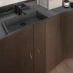 A kitchen with a sink and a mirror