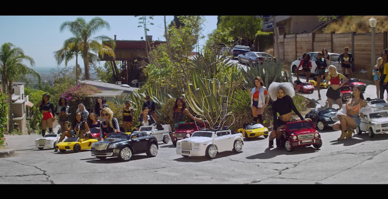 A group of people riding on the back of a car