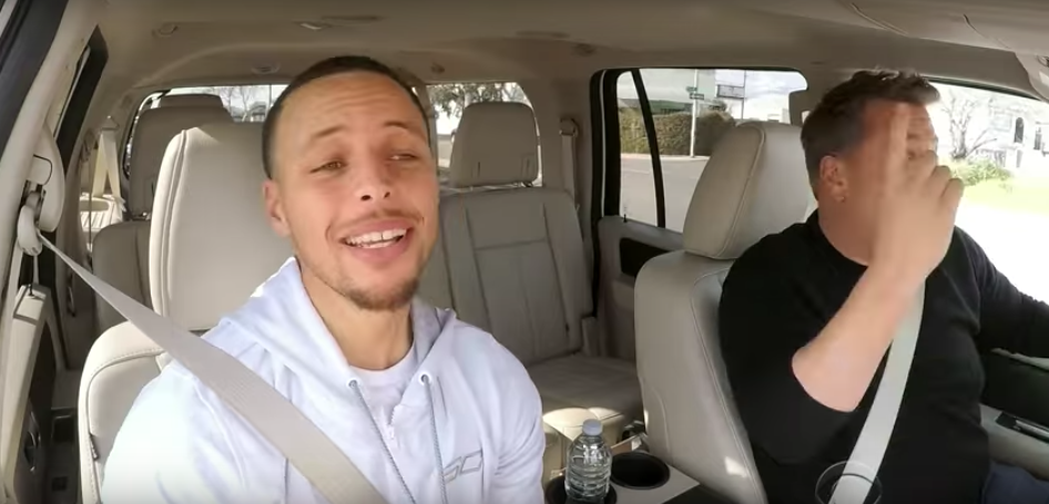 A man and a woman sitting on the seat of a car