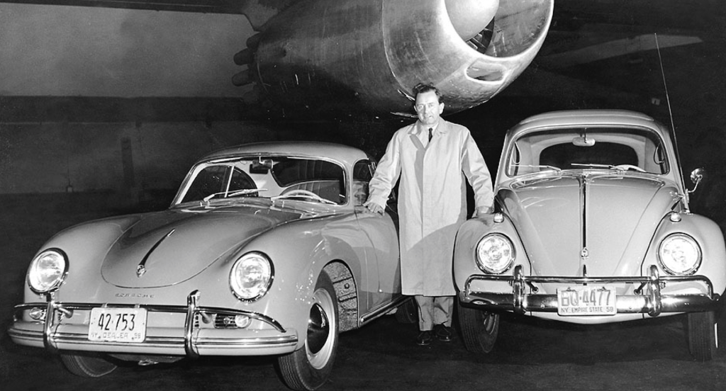 A person standing in front of a car