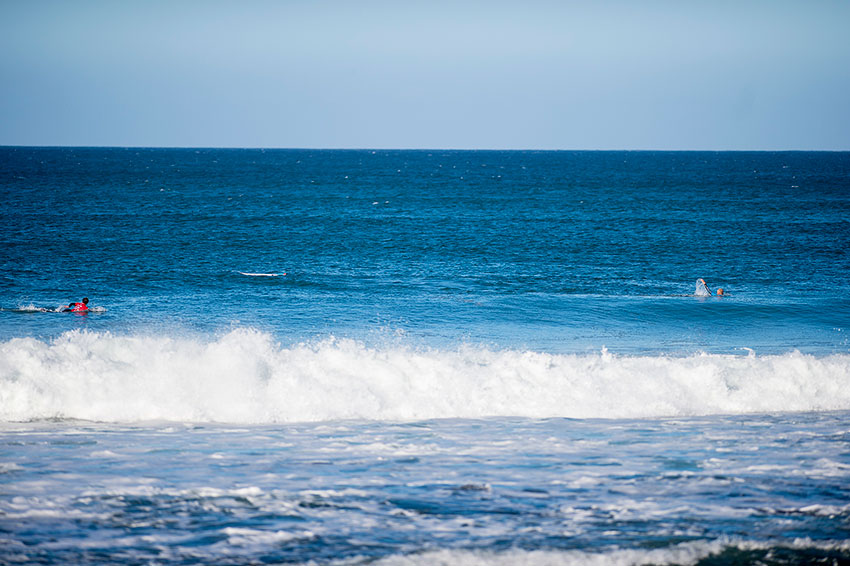 A man riding a wave on top of a body of water