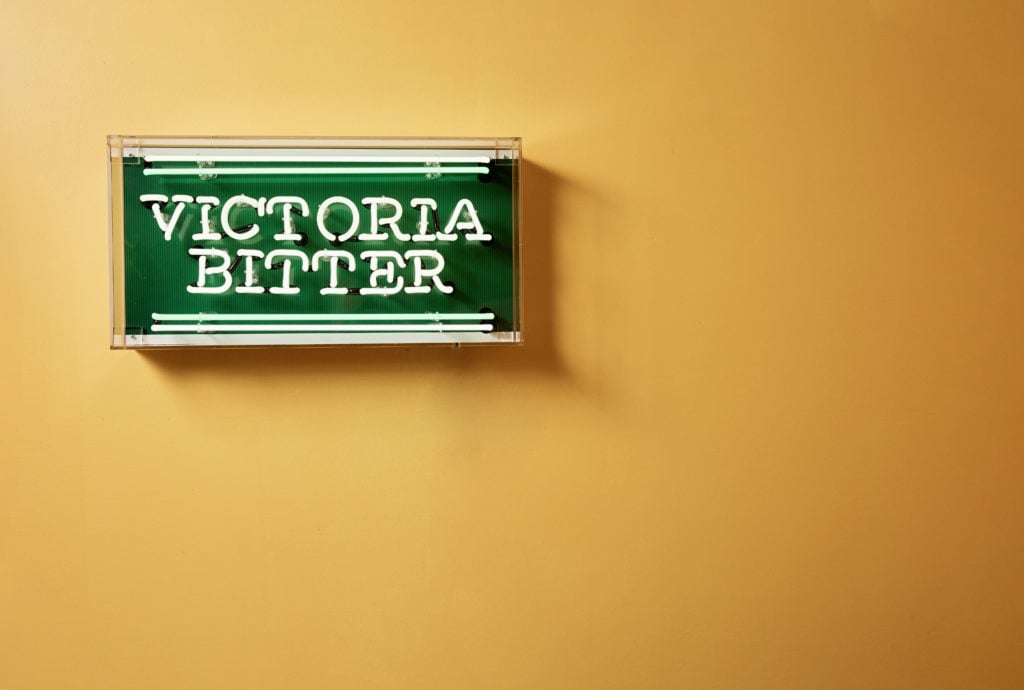 A sign hanging on a wall