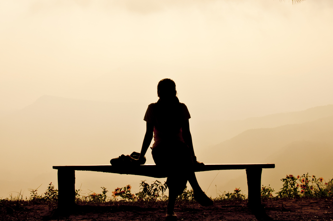 A person standing in front of a sunset