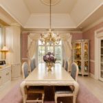 A room filled with furniture and vase of flowers on a kitchen counter