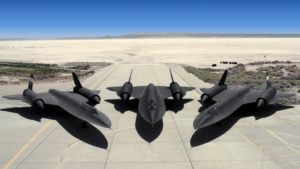 A fighter jet sitting on top of a beach