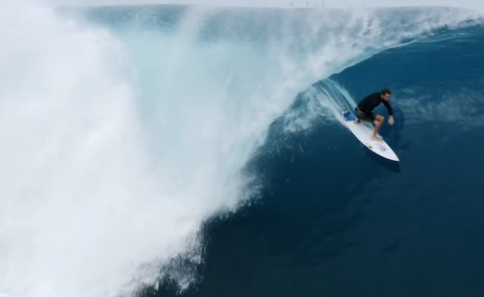 A man riding a wave on a surfboard in the water