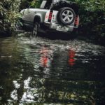 A car parked on the side of a river